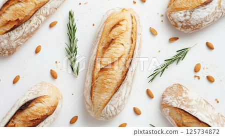 Artisan bread loaves with crispy crust on white background, top view 125734872