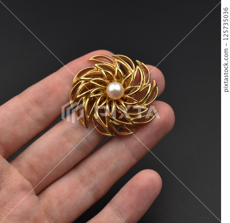 Fashion brooch floral vintage design laid on fabric Fashion brooch floral vintage design laid on fabric 125735036