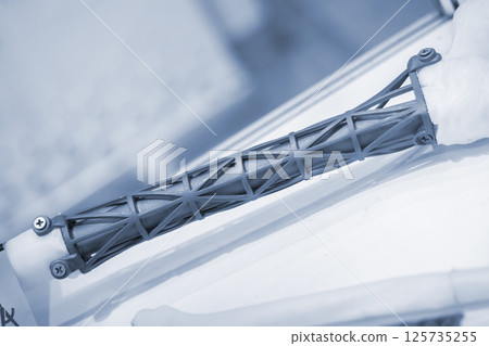 Implants and prostheses printed on 3D printer from biocompatible titanium powder. Titanium implant replacement of tubular bones on white human bone printed on 3D printer. Endoprostheses Bioengineering Implants and prostheses printed on 3D printer from biocompatible titanium powder. Titanium implant replacement of tubular bones on white human bone printed on 3D printer. Endoprostheses Bioengineering 125735255