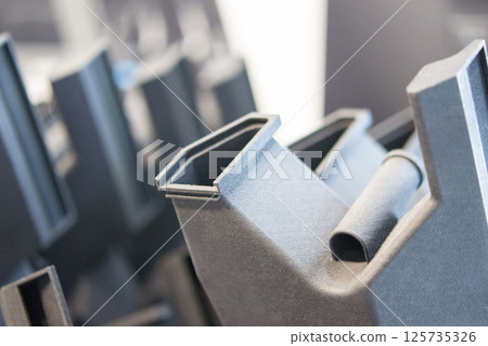 Plastic model printed on 3D printer from powder close-up. Objects created on 3D printer from polyamide powder. New 3D printing technology. Modern additive progressive 3D printing technologies. MJF 125735326