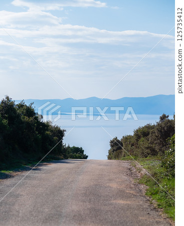 View of the sea and mountains from the road on the hill 125735412