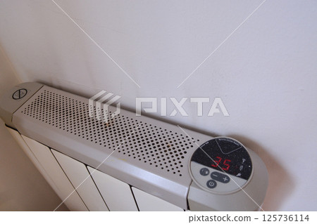 white modern heating knob on high battery mode for heating in apartments and houses. Heating prices. Concept of electricity price increase, electricity saving, reasonable consumption white modern heating knob on high battery mode for heating in apartments and houses. Heating prices. Concept of electricity price increase, electricity saving, reasonable consumption 125736114