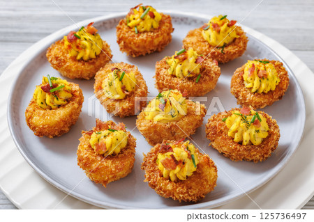 Deep fried deviled eggs with coating of panko 125736497