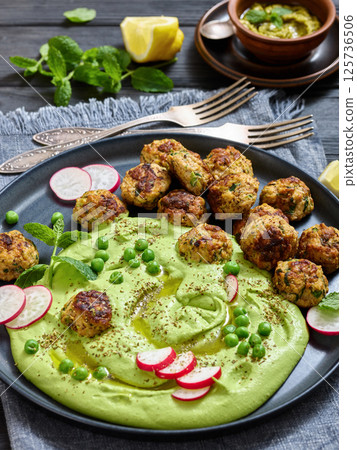 chicken broccoli meatballs with green pea hummus 125736506