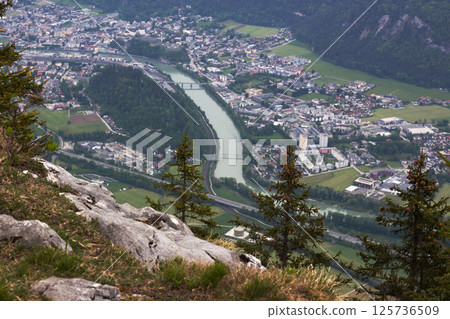 Stunning aerial view of Kufstein, Austria, capturing the river meandering through lush valleys and charming town nestled beneath majestic mountain peaks during a serene afternoon Stunning aerial view of Kufstein, Austria, capturing the river meandering through lush valleys and charming town nestled beneath majestic mountain peaks during a serene afternoon 125736509