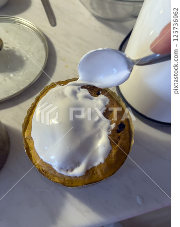 Homemade baking, preparation for spring holiday of Easter. The process of decorating Easter cakes with sweet colored decorations. The concept of making Easter cake Homemade baking, preparation for spring holiday of Easter. The process of decorating Easter cakes with sweet colored decorations. The concept of making Easter cake 125736962