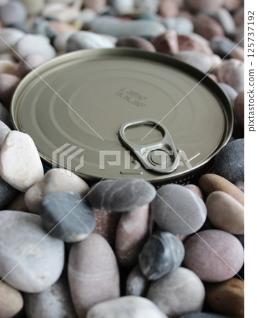 Flat Key Tin With Blurred Expiration Date Buried In Sea Stones 125737192