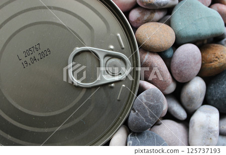 Canned Meat Conserve With Stamped Expiration Date Of 2029 Over Sea Pebbles 125737193