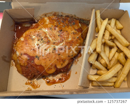 Traditional cheese chop and French fries in a cardboard delivery box Traditional cheese chop and French fries in a cardboard delivery box 125737267