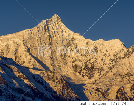 Meili Snow Mountains, Deqin County, Yunnan Province, China - The summit of Mt. Kawakabu in the morning sun Meili Snow Mountains, Deqin County, Yunnan Province, China - The summit of Mt. Kawakabu in the morning sun 125737403