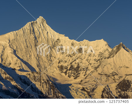 Meili Snow Mountains, Deqin County, Yunnan Province, China - The summit of Mt. Kawakabu in the morning sun Meili Snow Mountains, Deqin County, Yunnan Province, China - The summit of Mt. Kawakabu in the morning sun 125737405