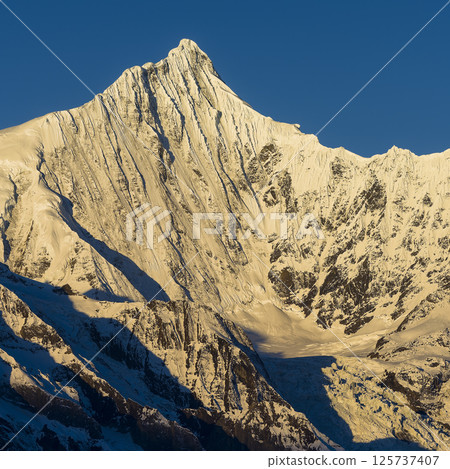 Meili Snow Mountains, Deqin County, Yunnan Province, China - The summit of Mt. Kawakabu in the morning sun Meili Snow Mountains, Deqin County, Yunnan Province, China - The summit of Mt. Kawakabu in the morning sun 125737407