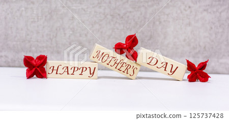 Happy Mother's Day is written on three wooden blocks. Beautiful background 125737428
