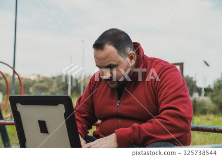 Man Doing His Digital Job From The City Park Man Doing His Digital Job From The City Park 125738544