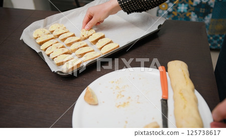 A Woman Distributes Cantucci Typical Italian Biscuits In A Baking Dish 125738617