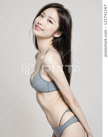 Beautiful woman wearing bikini photographed in studio 125742167