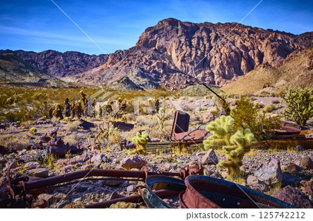 Rusted Relic in Desert Landscape with Mountain Backdrop Eye-Level View Rusted Relic in Desert Landscape with Mountain Backdrop Eye-Level View 125742212