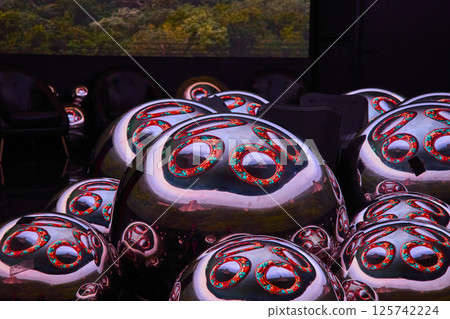 Metallic Spheres with Floral Patterns in Park Low Angle View Metallic Spheres with Floral Patterns in Park Low Angle View 125742224