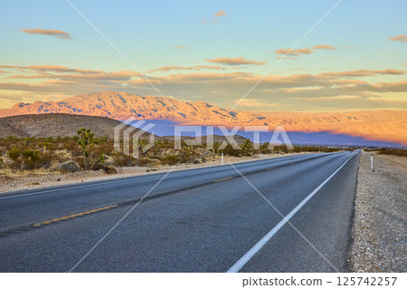Desert Road at Sunset with Mountain View Eye-Level Perspective 125742257