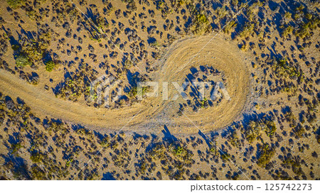 Aerial Top Down of Winding Desert Road in Nevada at Golden Hour 125742273