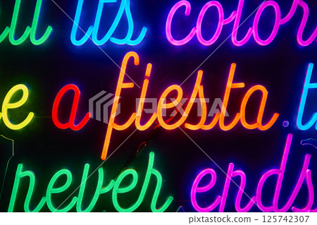 Vibrant Neon Fiesta Sign Urban Nightlife Eye-Level Perspective 125742307