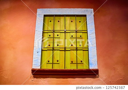 Vibrant Lime Green Shutters on Terracotta Wall Eye-Level Perspective Vibrant Lime Green Shutters on Terracotta Wall Eye-Level Perspective 125742387