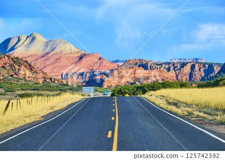 Desert Road to Kolob Canyon with Majestic Mountain Backdrop Eye-Level View 125742392