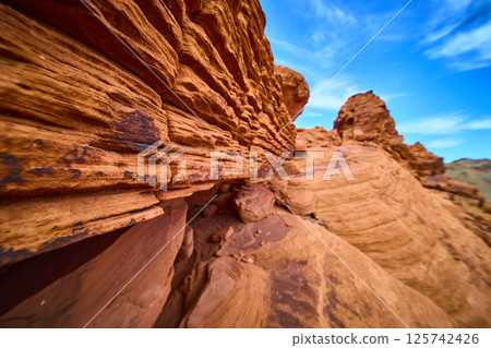 Rugged Sandstone Striations in Desert Sun Low Perspective View 125742426