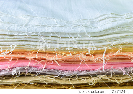 stack of colourful cotton clothes, close up pile of clothing stack of colourful cotton clothes, close up pile of clothing 125742463