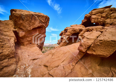 Rugged Sandstone Formations Under Vibrant Sky Eye-Level View 125742486