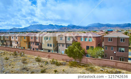 Aerial of Modern Desert Homes with Mountain Backdrop 125742636