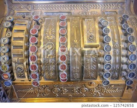 Antique Cash Register with Ornate Metalwork Eye-Level Close-Up Antique Cash Register with Ornate Metalwork Eye-Level Close-Up 125742658