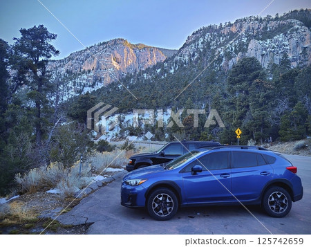 Mountain Viewpoint with Parked Vehicles in Late Afternoon Light Mountain Viewpoint with Parked Vehicles in Late Afternoon Light 125742659