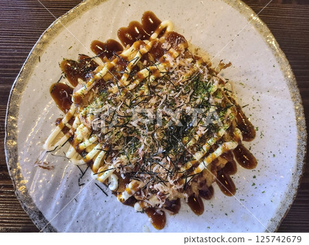 Okonomiyaki Savory Pancake with Bonito Flakes Eye-Level Perspective Okonomiyaki Savory Pancake with Bonito Flakes Eye-Level Perspective 125742679