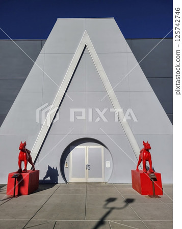 Geometric Facade with Red Dog Statues in Urban Setting Eye Level View 125742746