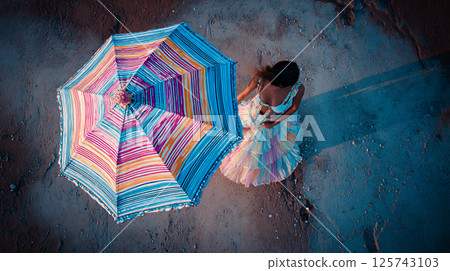 Aerial view of a woman in a dress with a colorful umbrella 125743103