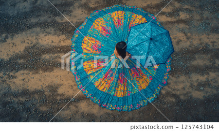 Aerial view of a woman in a dress with a colorful umbrella 125743104