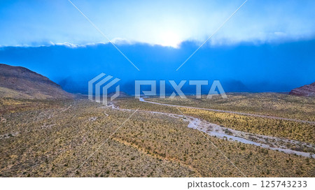 Aerial of Nevada Desert Storm Over Rugged Terrain 125743233