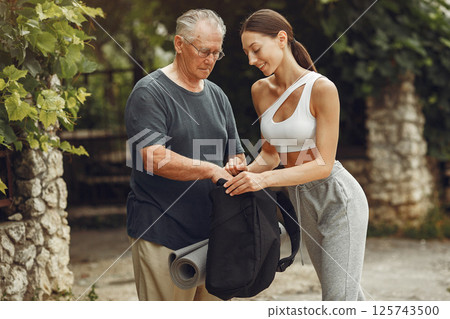 Senior man at summer park. Grangfather with granddaughter. Senior man at summer park. Grangfather with granddaughter. 125743500