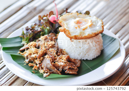 stir fried pork with garlic , pork and rice or deep fried pork or fried pork with rice and sunny side up egg or fried egg stir fried pork with garlic , pork and rice or deep fried pork or fried pork with rice and sunny side up egg or fried egg 125743792