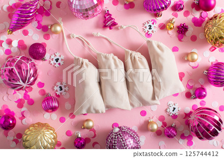 Christmas advent calendar with gift velvet bags on a pink background. Environmentally friendly. Christmas advent calendar with gift velvet bags on a pink background. Environmentally friendly. 125744412