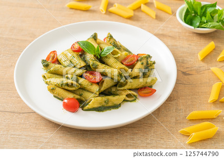 penne pasta with pesto sauce and tomatoes 125744790