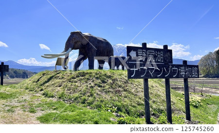 The statue of the mother and child Naumann's elephant at Lake Nojiri and the remaining snow on Mt. Kurohime from National Route 18 125745260
