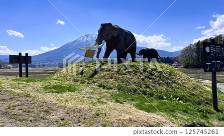 The statue of the mother and child Naumann's elephant at Lake Nojiri and the remaining snow on Mt. Kurohime from National Route 18 The statue of the mother and child Naumann's elephant at Lake Nojiri and the remaining snow on Mt. Kurohime from National Route 18 125745261