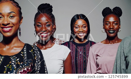 Four Beautiful Young Women Smiling and Posing Together 125745899