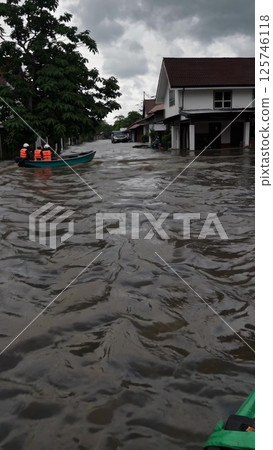 Rescuers Navigating Flooded Streets in Indonesia 125746118