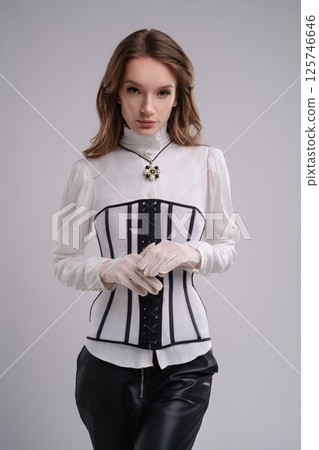 Elegant woman exuding charm in corset lingerie and chic gloves 125746646