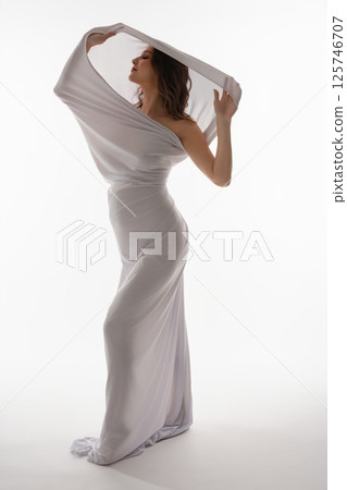 Pregnant woman gracefully showcases beauty in elegant attire Pregnant woman gracefully showcases beauty in elegant attire 125746707