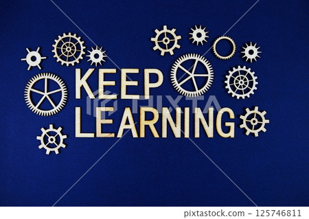Keep Learning alphabet letters with gears element on navy blue background 125746811