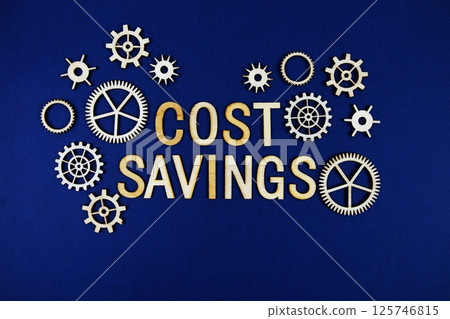 Cost Savings alphabet letters with gears element on navy blue background Cost Savings alphabet letters with gears element on navy blue background 125746815